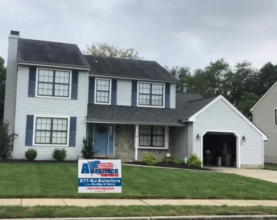 new roof replacement on porch and garage dark shingles light siding